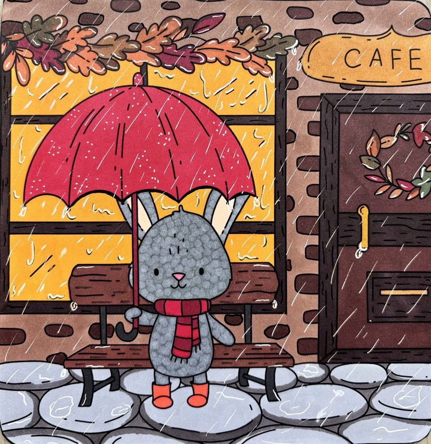 Coloriage cosy effet pluie avec lapin sous un parapluie devant un café